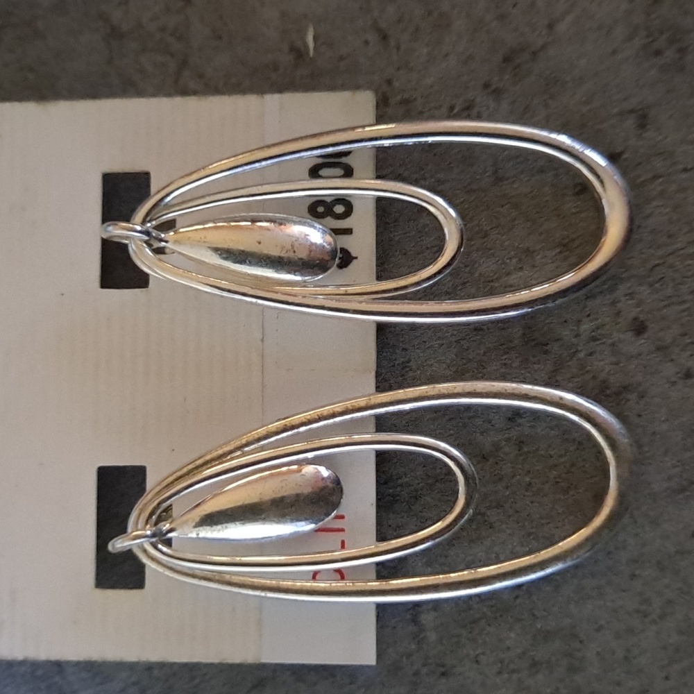 Designer Anne Klein Silvertone clip on silvertone earrimgs.